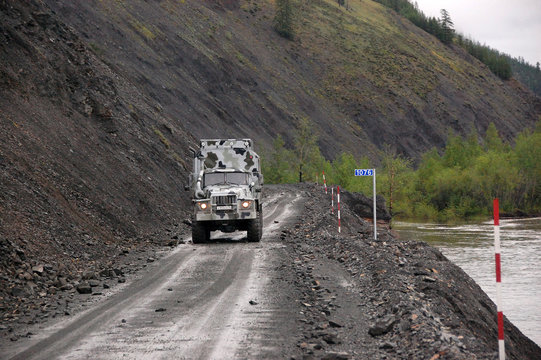 Truck at gravel road Kolyma highway outback Russia