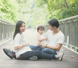 asian family enjoying outdoor park , vintage tone