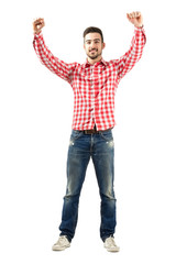 Excited man with clenched fist raise hands