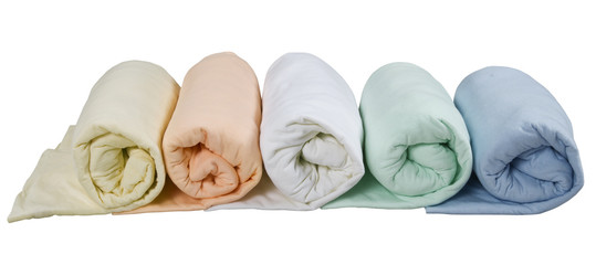 row of colorful twisted blankets isolated on white background