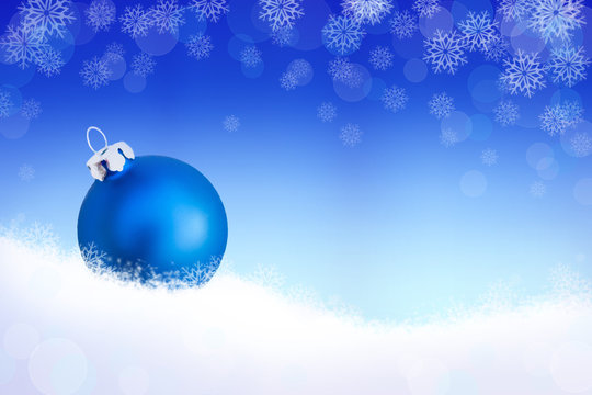 Background with blue christmas ball in the snow