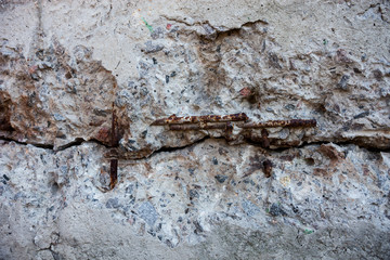 Cracked grey concrete surface with visible reinforcement