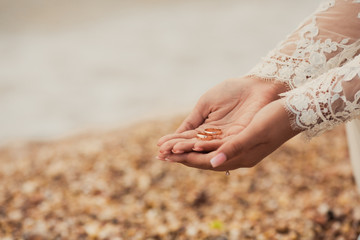 Wedding rings on hands of bride