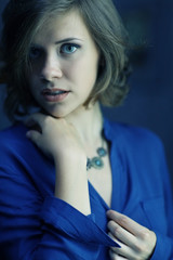 Naklejka premium portrait of a beautiful sad girl in a blue dress
