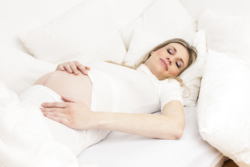 Fototapeta na wymiar pregnant woman sleeping in bed