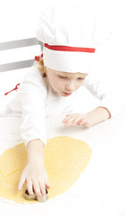 little girl cutting cookies