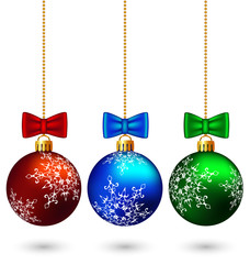 Three multicolored christmas balls with bows hang on the chain i