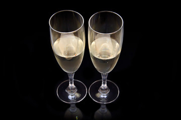 Flute with sparkling wine on black