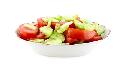dish from tomatoes and cucumbers isolated