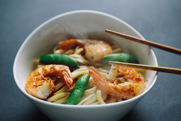 hot noodles with shrimps on a black background