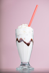 vanilla milkshake on pink background