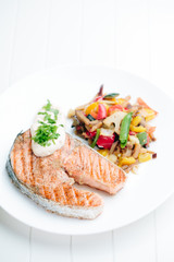 Grilled Salmon with Fresh vegetables on white background