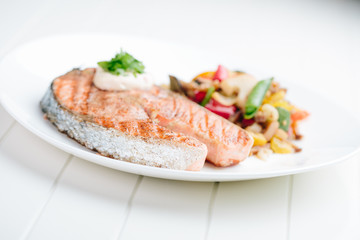 Grilled Salmon with Fresh vegetables on white background