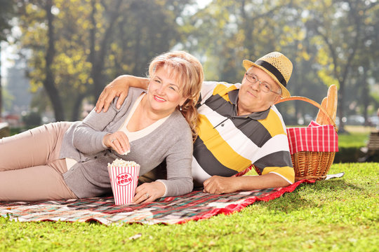 Mature Couple Enjoying A Picnic In The Park