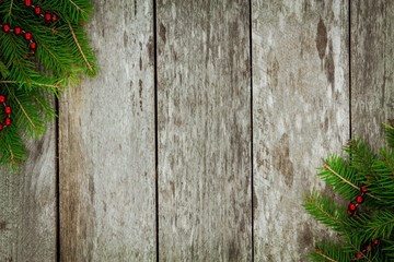 Pine tree with red garland on old wooden background