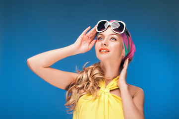 Charming blonde girl in vintage yellow dress and sunglasses