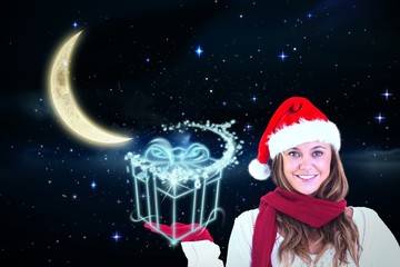 Composite image of festive blonde presenting with hand