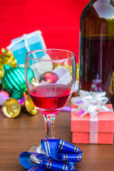 Glass of wine and colorful gifts