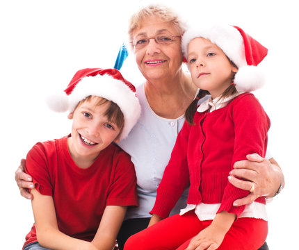 grandmother with grandchildren in santa hats
