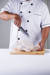 Chef prepared chopping raw chicken