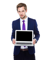 Businessman show with blank screen of laptop computer