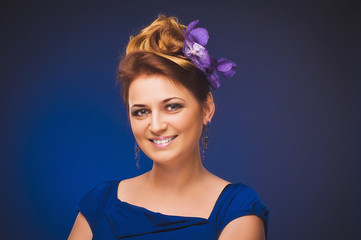 Photo of a young woman with flowers. Plus size model.