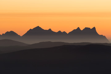 mountain range in late sunset - obrazy, fototapety, plakaty