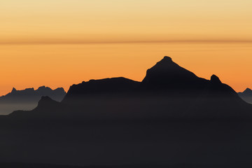 mountains in sunset haze - obrazy, fototapety, plakaty