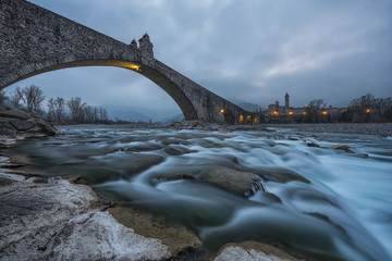 The old town of Bobbio and the bridge Gobbo by night, Italy - obrazy, fototapety, plakaty