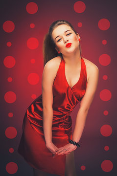 Kiss. Brunette in a red dress. Vintage.