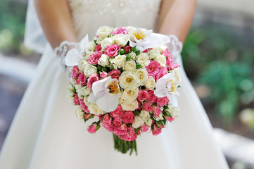 wedding bouquet at bride's hands. studio shot