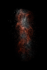 Fototapeta na wymiar Stop motion of white and red dust explosion isolated on black ba
