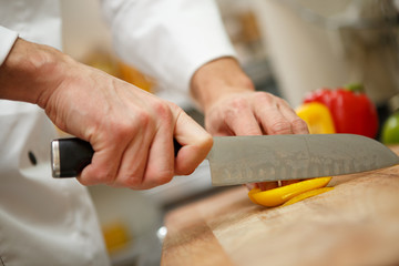 man's hands cutting pepper. Salad preparation