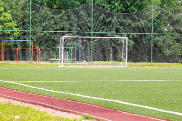 Football goal on a green field on a background