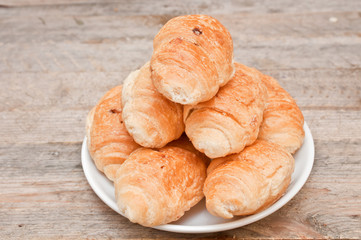croissants in a saucer on a wooden table