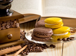 Coffee with macaroon, cinnamon and culinary book