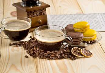 Coffee cup with macaroon and newspaper
