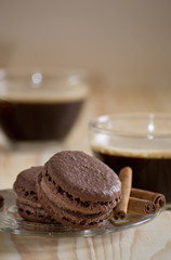Coffee cup with macaroon and cinnamon sticks
