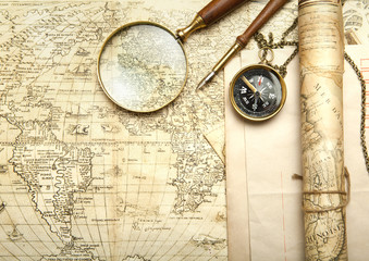Fototapeta na wymiar An brass compass on a old map background