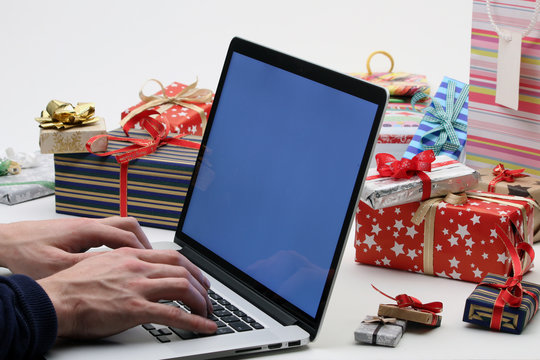 Man With Laptop & Christmas Gifts - Online Shopping Concept