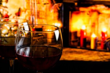 red wine glass against christmas lights decoration background