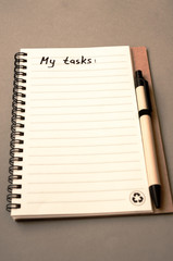 Hand drawing tasks list on notebook