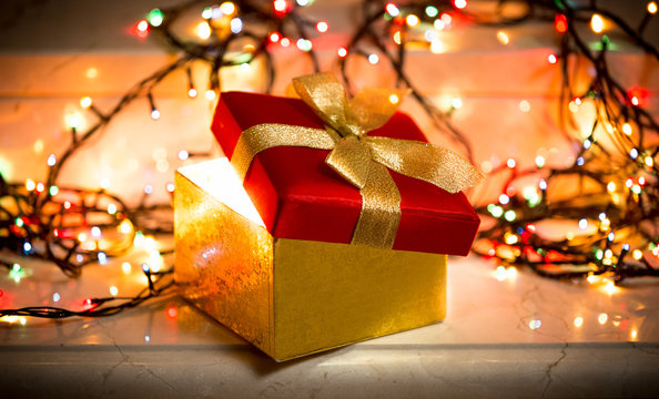 open gift box with light coming out of it - Powered by Adobe