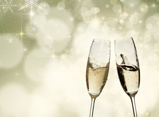 Toasting with champagne glasses on sparkling holiday background