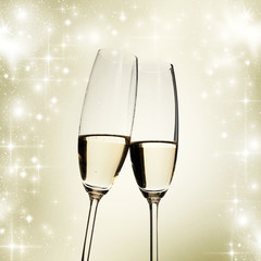 Toasting with champagne glasses on sparkling holiday background