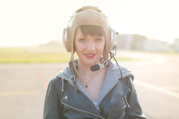 Portrait of young pilot against the sun with lens flare