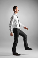 business and education concept- businessman stepping on