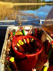 Bucket full of colorful pike fishing lures