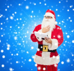 man in costume of santa claus with notepad