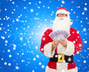 man in costume of santa claus with euro money